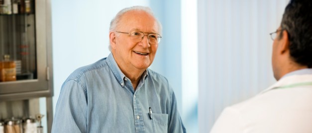 Senior couple talking with doctor.